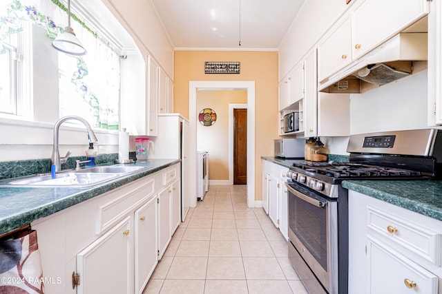 kitchen featuring under cabinet range hood, ornamental molding, light tile patterned flooring, stainless steel appliances, and a sink