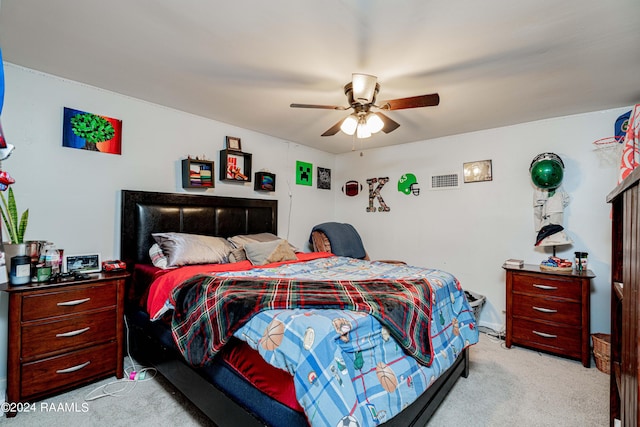 bedroom with a ceiling fan and light carpet
