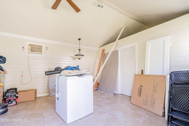laundry room featuring wooden walls, ceiling fan, a wall unit AC, laundry area, and washer / clothes dryer