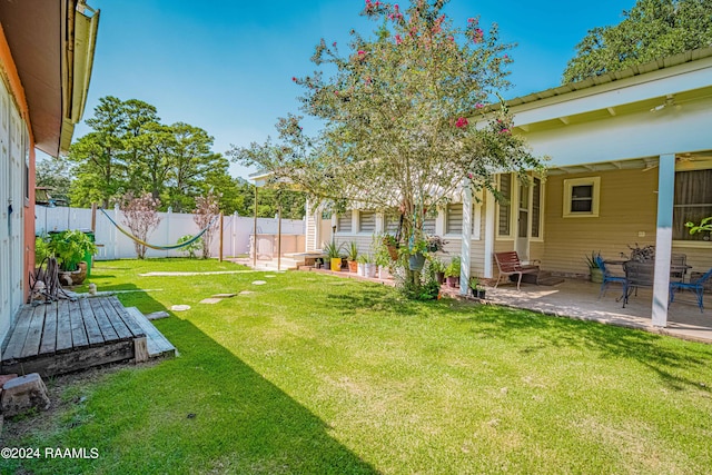 view of yard featuring entry steps, a fenced backyard, and a patio