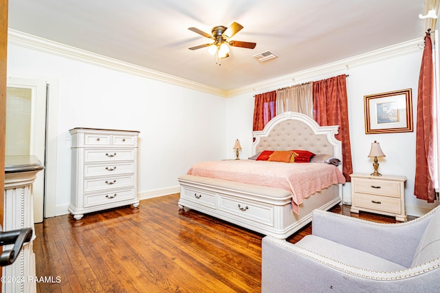 bedroom featuring visible vents, dark wood finished floors, and ornamental molding