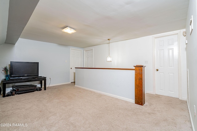 below grade area featuring carpet and baseboards