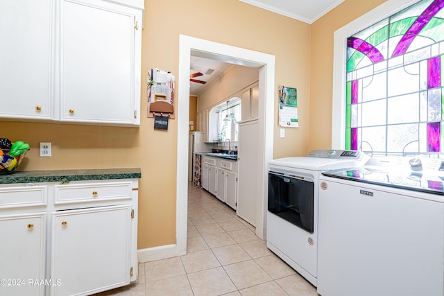 kitchen featuring washer and clothes dryer, white cabinetry, crown molding, light tile patterned floors, and ceiling fan
