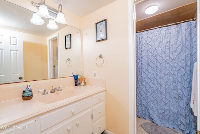 bathroom with vanity and curtained shower