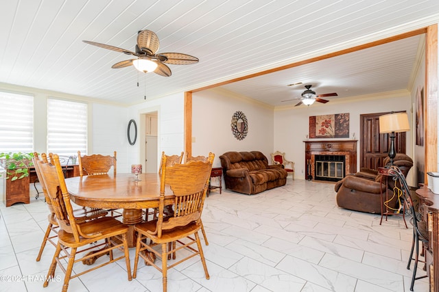dining room featuring marble finish floor, crown molding, and ceiling fan