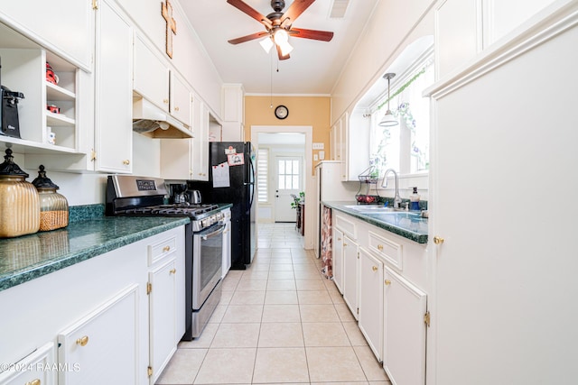 kitchen with visible vents, a sink, light tile patterned flooring, crown molding, and stainless steel range with gas stovetop
