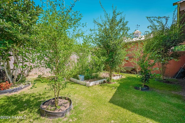 view of yard with a fenced backyard and a vegetable garden