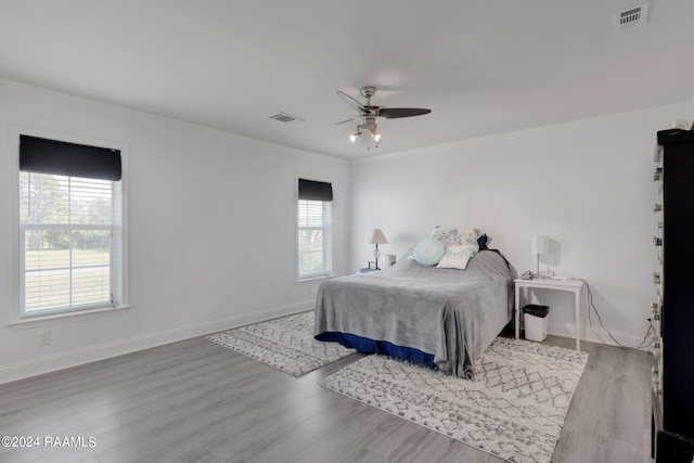 bedroom with ceiling fan and light hardwood / wood-style flooring