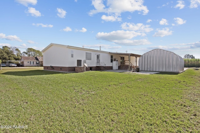 rear view of property featuring a lawn and a patio