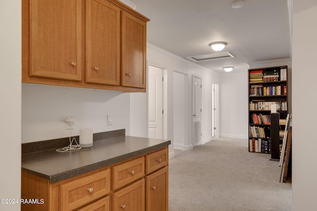 kitchen with light colored carpet and ornamental molding