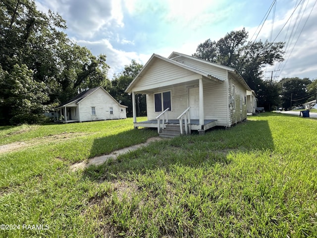bungalow-style home featuring a porch and a front yard
