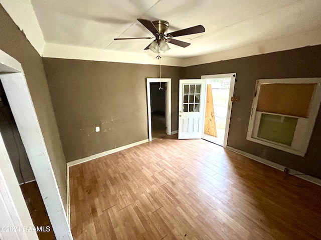 unfurnished bedroom featuring ceiling fan, wood finished floors, and baseboards