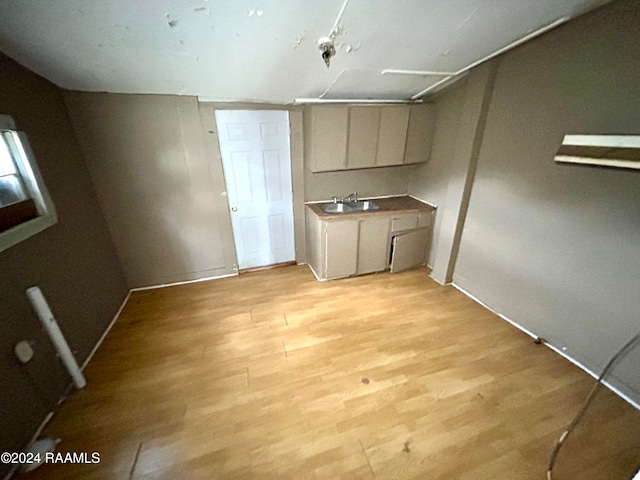 kitchen featuring a sink and light wood-style flooring
