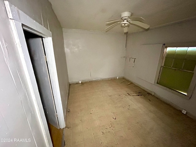 spare room with light floors and a ceiling fan
