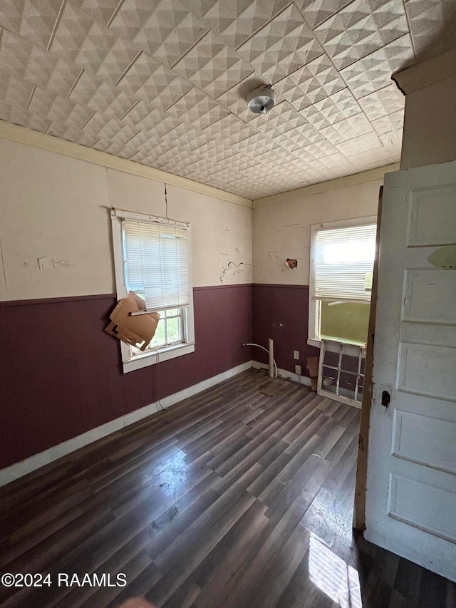 empty room featuring a wainscoted wall and wood finished floors