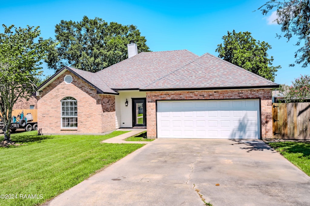 view of front of home with a garage and a front yard