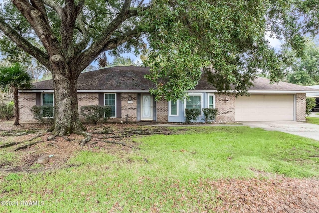 ranch-style house with an attached garage, a front lawn, concrete driveway, and brick siding