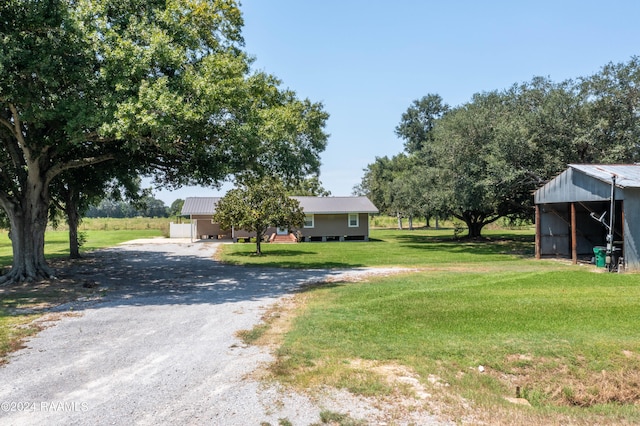 exterior space featuring a front lawn and an outdoor structure