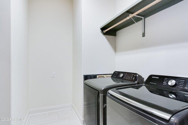 laundry area featuring light tile patterned floors and separate washer and dryer