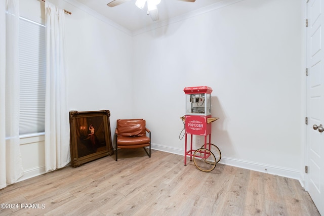 living area with ceiling fan, light hardwood / wood-style flooring, and crown molding