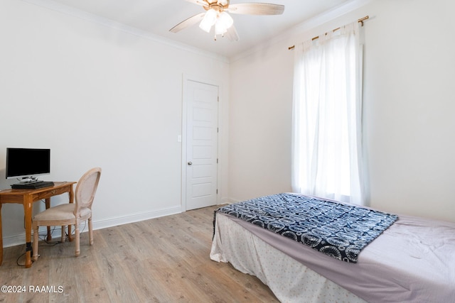 bedroom featuring ceiling fan, light hardwood / wood-style flooring, ornamental molding, and multiple windows