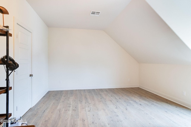 bonus room featuring light hardwood / wood-style floors and vaulted ceiling