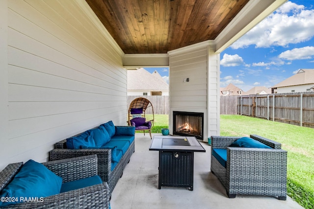 view of patio with an outdoor living space with a fireplace