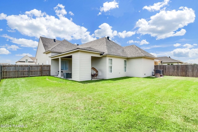 back of house featuring a patio area and a yard