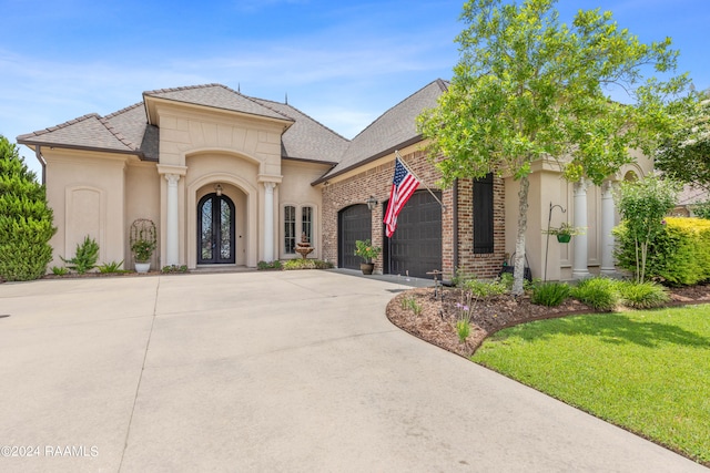 view of front of property featuring a garage and a front lawn