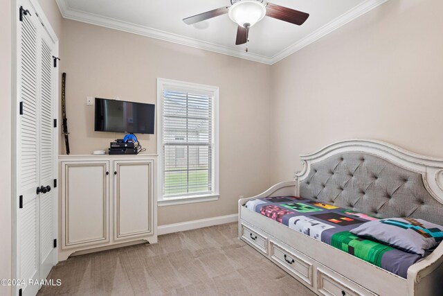 carpeted bedroom featuring a closet, ceiling fan, and crown molding