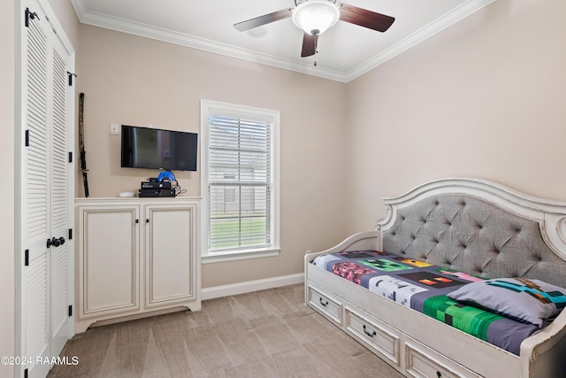 bedroom featuring light carpet, ceiling fan, baseboards, and crown molding