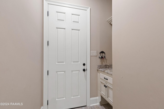 interior space featuring baseboards and vanity