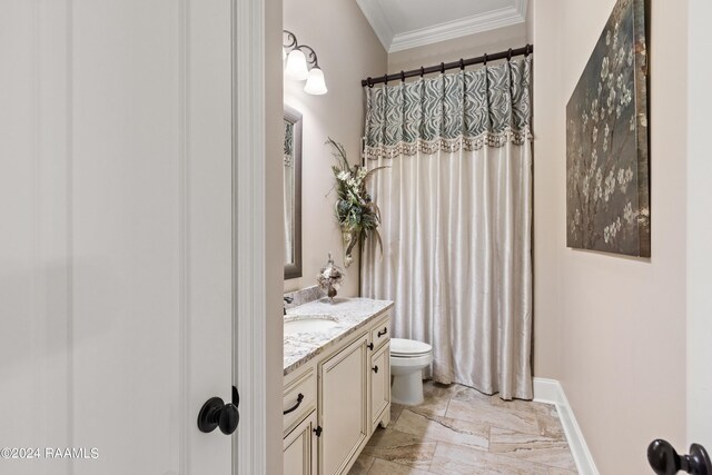 bathroom with crown molding, tile patterned floors, toilet, and vanity