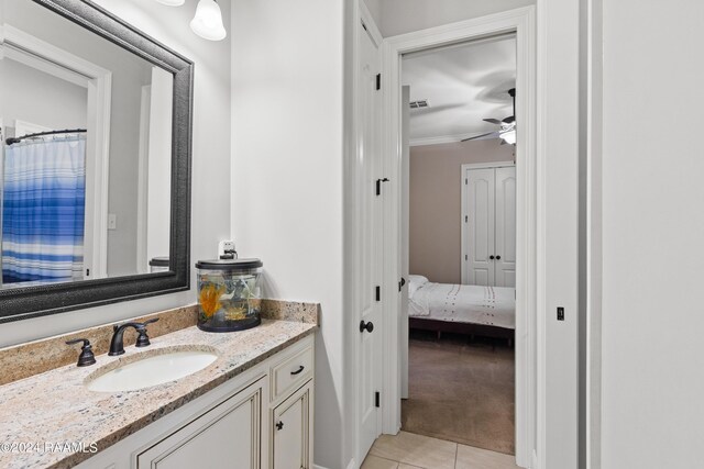 bathroom with ceiling fan, tile patterned flooring, crown molding, and vanity