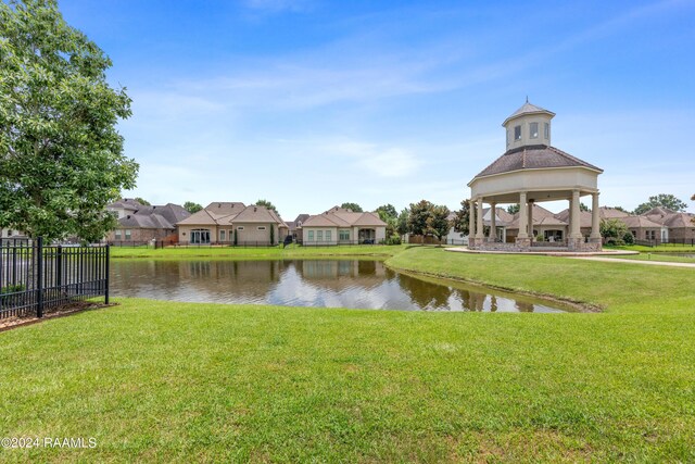 property view of water with a residential view, fence, and a gazebo