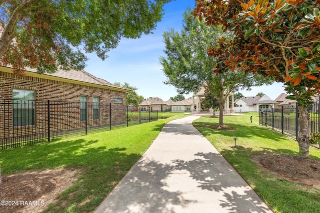 view of property's community with a lawn