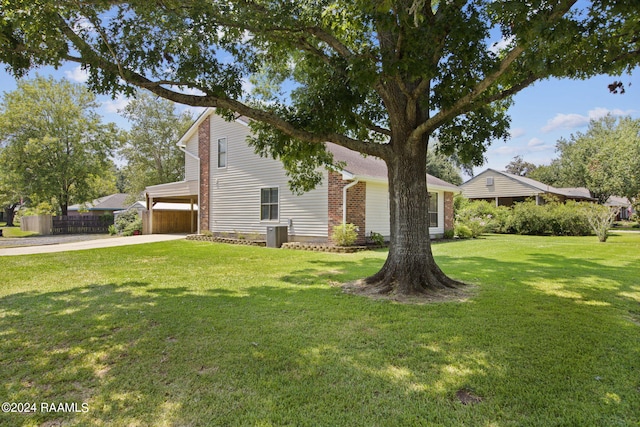 view of side of property featuring cooling unit, a lawn, and a garage