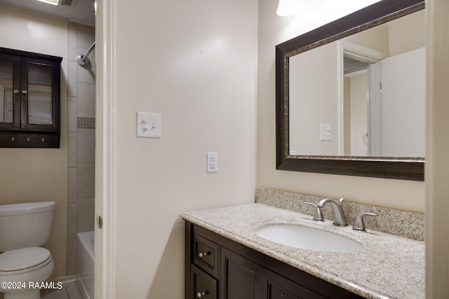 full bathroom featuring toilet, tiled shower / bath combo, and vanity