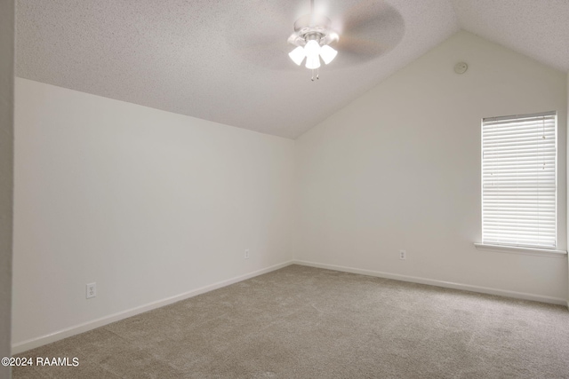 bonus room featuring lofted ceiling, light colored carpet, ceiling fan, and a textured ceiling