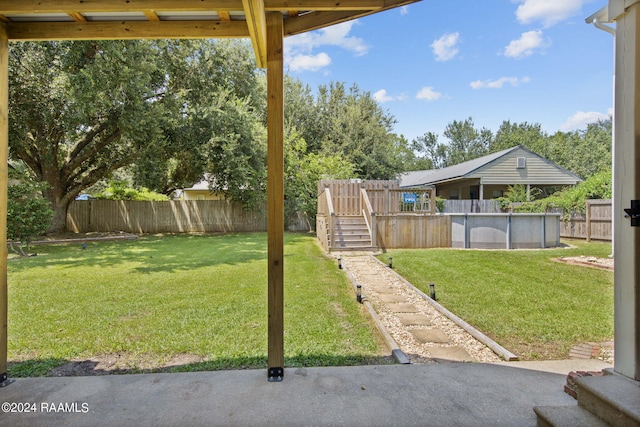 view of yard with a fenced in pool