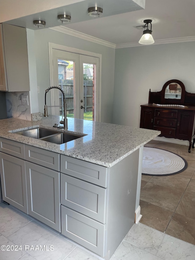 kitchen featuring light tile patterned flooring, sink, and gray cabinets