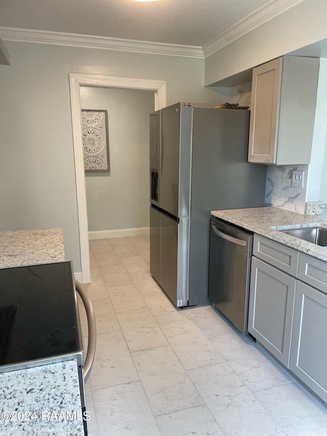 kitchen with tasteful backsplash, stainless steel dishwasher, gray cabinets, and light tile patterned floors