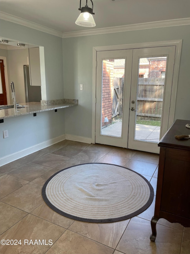 doorway with light tile patterned floors, sink, ornamental molding, and french doors