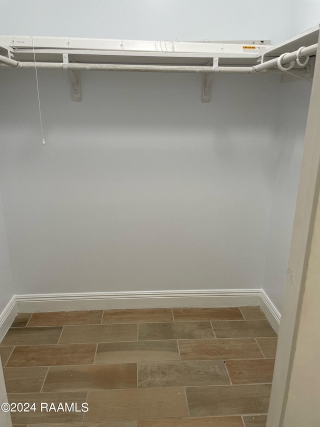 spacious closet featuring hardwood / wood-style flooring