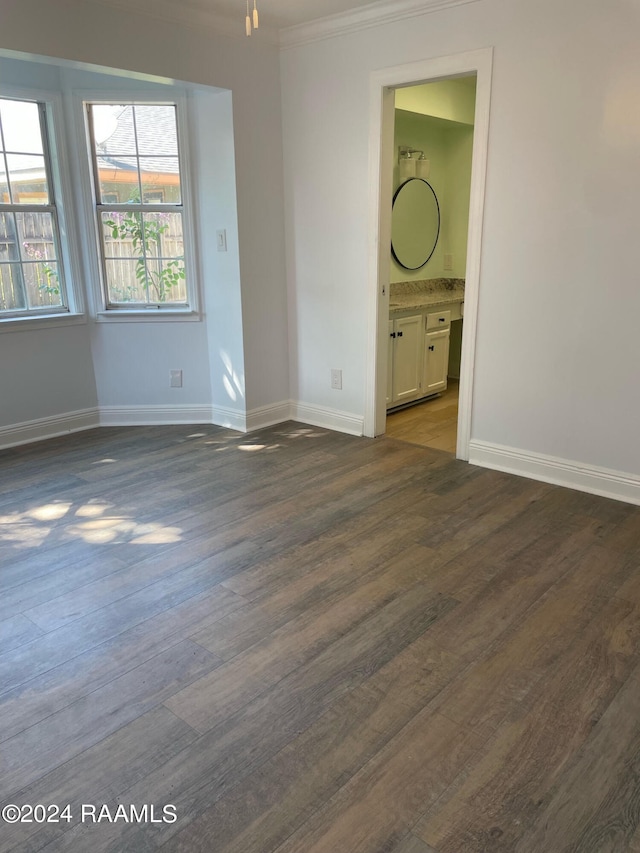 unfurnished room with dark hardwood / wood-style floors and ornamental molding