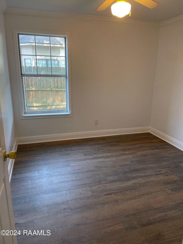 spare room featuring ceiling fan, hardwood / wood-style flooring, and crown molding