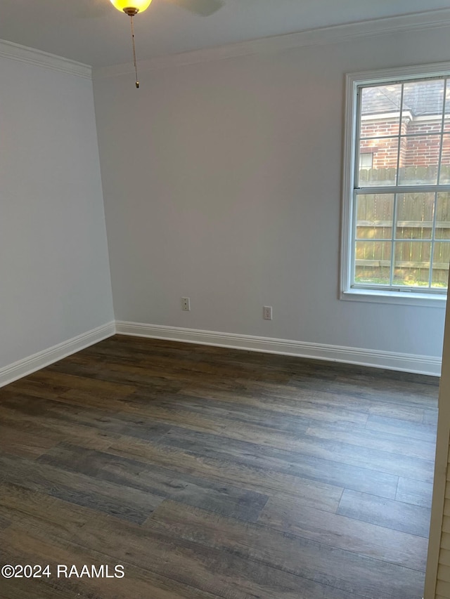 empty room featuring hardwood / wood-style flooring, crown molding, and a healthy amount of sunlight