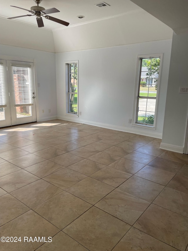 tiled spare room with ceiling fan and vaulted ceiling