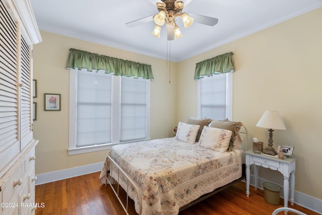 bedroom with dark wood-type flooring, baseboards, ceiling fan, and crown molding
