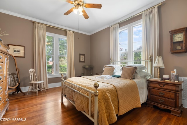 bedroom with a ceiling fan, ornamental molding, baseboards, and wood finished floors